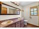 Bathroom features a double sink vanity with wood cabinets, a large mirror, and a tiled shower at 11632 Lake Willis Dr, Orlando, FL 32821