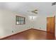 Spacious bedroom featuring wood floors, a ceiling fan, natural light and a wood door at 11632 Lake Willis Dr, Orlando, FL 32821