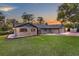 Charming single-story brick home with well-maintained lawn and colorful sunset sky at 11632 Lake Willis Dr, Orlando, FL 32821
