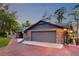 Brick home with a two-car garage and brick driveway, enhanced by professional landscaping at 11632 Lake Willis Dr, Orlando, FL 32821