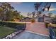 Brick home with a two-car garage and brick driveway surrounded by a manicured lawn at 11632 Lake Willis Dr, Orlando, FL 32821