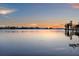 Picturesque lake reflecting the sunset sky, offering a peaceful waterfront living experience at 11632 Lake Willis Dr, Orlando, FL 32821