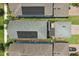 An aerial view shows rooftops with solar panels and well-maintained green lawns at 12127 Sonnet Ave, Orlando, FL 32832