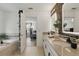 Tastefully designed bathroom showcasing double sinks, modern fixtures, black stone wall, and a glimpse of the bedroom at 12127 Sonnet Ave, Orlando, FL 32832