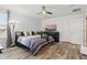 Comfortable bedroom with natural light, hardwood floors, and a modern entertainment center at 12127 Sonnet Ave, Orlando, FL 32832