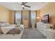 Sunny bedroom with lots of natural light, a comfortable bed, and a view of the outdoors at 12127 Sonnet Ave, Orlando, FL 32832