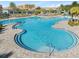 A spacious community pool featuring a zero entry, lounge chairs, and resort-style amenities at 12127 Sonnet Ave, Orlando, FL 32832