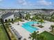 A community pool surrounded by palm trees, lounge chairs, and a covered area with tables at 12127 Sonnet Ave, Orlando, FL 32832