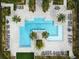 Aerial view of a community pool with plenty of lounge chairs and umbrellas at 12127 Sonnet Ave, Orlando, FL 32832