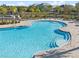 Beautiful community pool featuring a zero entry, lounge chairs, and resort-style amenities at 12127 Sonnet Ave, Orlando, FL 32832
