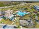A beautiful community pool area with a playground, club house, and tennis courts, all landscaped with palm trees at 12127 Sonnet Ave, Orlando, FL 32832
