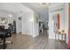 Open-concept entryway with wood-look tile flooring, decorative lighting, and neutral paint at 12127 Sonnet Ave, Orlando, FL 32832