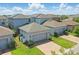 Street view of homes with attached garages, brick paver driveways, and manicured lawns at 12127 Sonnet Ave, Orlando, FL 32832