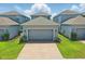 Street view of homes with attached garages, brick paver driveways, and manicured lawns at 12127 Sonnet Ave, Orlando, FL 32832