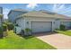 Attached two-car garage with brick paver driveway and manicured lawn at 12127 Sonnet Ave, Orlando, FL 32832