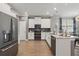 Modern kitchen with white cabinets, stainless steel appliances, and a large center island at 12127 Sonnet Ave, Orlando, FL 32832