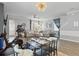 Open-concept living space with a dining table, comfortable seating, and a modern ceiling fan at 12127 Sonnet Ave, Orlando, FL 32832