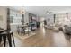 Open-concept living and dining area featuring hardwood floors, gray walls, and modern furnishings at 12127 Sonnet Ave, Orlando, FL 32832