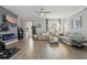 Cozy living room with hardwood flooring, a fireplace, and a comfortable sectional sofa at 12127 Sonnet Ave, Orlando, FL 32832