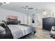 Comfortable main bedroom with light gray wood floors, ceiling fan, TV, and en suite bathroom at 12127 Sonnet Ave, Orlando, FL 32832