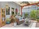 Cozy outdoor living space with covered pergola, comfortable seating, plants, and decorative accents at 12127 Sonnet Ave, Orlando, FL 32832
