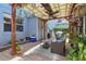 Relaxing covered patio area with ceiling fan, wicker seating, and lush plants at 12127 Sonnet Ave, Orlando, FL 32832