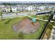 A neighborhood playground is surrounded by green grass, offering residents a fun outdoor space for children to play at 12127 Sonnet Ave, Orlando, FL 32832