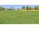 Sprawling backyard view with a home featuring a back porch, a fence, and lush greenery at 1271 Thoroughbred Trl, Sanford, FL 32771