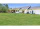 Wide backyard view with covered patio, a well-maintained lawn and the exterior of the house at 1271 Thoroughbred Trl, Sanford, FL 32771