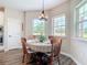 Charming dining area with natural light, wood-look floors, and a cozy atmosphere for Gathering meals at 1271 Thoroughbred Trl, Sanford, FL 32771