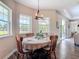 Bright dining area featuring wood-look floors, a stylish chandelier, and lots of natural light at 1271 Thoroughbred Trl, Sanford, FL 32771
