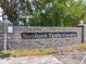 Stone entrance sign for Sanford Trails Estates with manicured landscaping at 1271 Thoroughbred Trl, Sanford, FL 32771