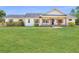 Beautiful white home featuring a charming front porch with wooden pillars, shutters, and a lush lawn at 1271 Thoroughbred Trl, Sanford, FL 32771