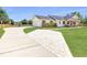 Charming home with a garage, rustic shutters, and a long driveway with a paved area at 1271 Thoroughbred Trl, Sanford, FL 32771
