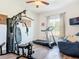 Home gym features a full machine, treadmill, and a cozy lounging area at 1271 Thoroughbred Trl, Sanford, FL 32771