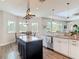 Bright kitchen with stainless appliances, granite counters, island, and breakfast nook area at 1271 Thoroughbred Trl, Sanford, FL 32771