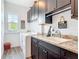 Laundry room with washer, dryer, sink, dark cabinets and granite countertop at 1271 Thoroughbred Trl, Sanford, FL 32771