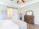 Charming main bedroom featuring wood-look floors, a barn door, and a dresser with a large mirror at 1271 Thoroughbred Trl, Sanford, FL 32771