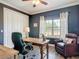 Inviting home office with a wooden desk, leather chair, and bright window overlooking the beautiful scenery at 1271 Thoroughbred Trl, Sanford, FL 32771