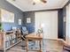 Charming home office with dark blue walls, a wooden desk, built-in shelves, and cozy leather chairs at 1271 Thoroughbred Trl, Sanford, FL 32771