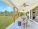 Relaxing covered patio with outdoor furniture and a beautiful backyard view at 1271 Thoroughbred Trl, Sanford, FL 32771