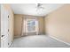 This carpeted bedroom has a ceiling fan, neutral walls, and large window with curtains at 12977 Borland St, Windermere, FL 34786