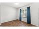 Bright, minimalist bedroom with wood-look flooring and ample natural light at 12977 Borland St, Windermere, FL 34786