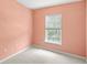 Bedroom with peach walls, carpet and window with blinds letting in natural light at 12977 Borland St, Windermere, FL 34786