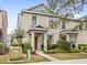 Inviting two-story townhome with neutral paint, decorative shutters, and manicured landscaping at 12977 Borland St, Windermere, FL 34786