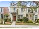 Inviting two-story townhome with neutral paint, decorative shutters, and manicured landscaping at 12977 Borland St, Windermere, FL 34786
