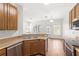 Bright kitchen features stainless steel appliances, granite countertops, and wood cabinets at 12977 Borland St, Windermere, FL 34786