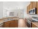 Bright kitchen features stainless steel appliances, granite countertops, and wood cabinets at 12977 Borland St, Windermere, FL 34786