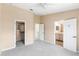 Carpeted main bedroom has a ceiling fan, walk-in closet, and en-suite bathroom access at 12977 Borland St, Windermere, FL 34786