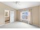 Carpeted main bedroom has a ceiling fan, neutral walls, and en-suite bathroom access at 12977 Borland St, Windermere, FL 34786